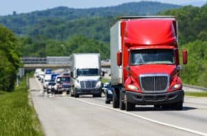 Red trailer truck leading the way to delivery.