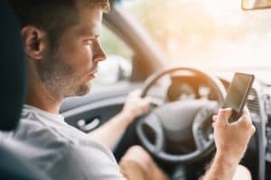 Driver is texting while driving.