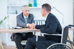 A Richmond workers' compensation lawyer shaking the hand of his client. 