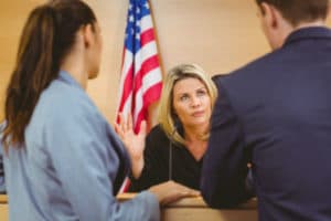 Our wrongful death attorney talking to a judge during a trial. 