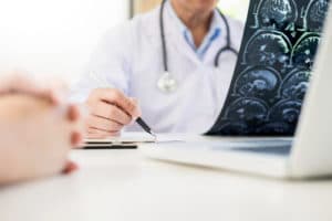 A doctor in Richmond goes over a ct scan with a patient.