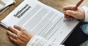 Woman reading settlement document from insurance.