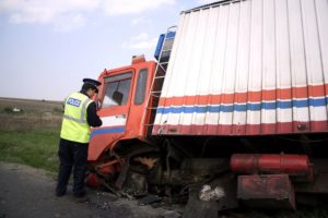 Police officer checking the ditch truck accident.
