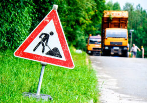 Men at work sign at a road construction site.