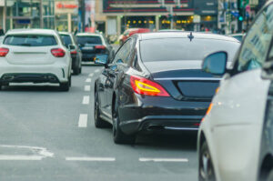 Black car signaling left to change lane.