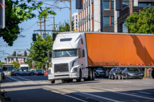 Truck making left turn towards city proper.