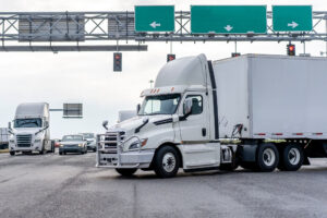 White semi tractor trailer merging onto highway