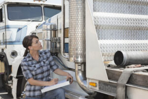 Insurance agent inspecting truck for damages.