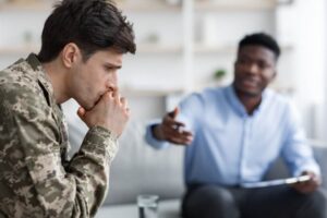 Military soldier suffering ptsd consulting psychologist.