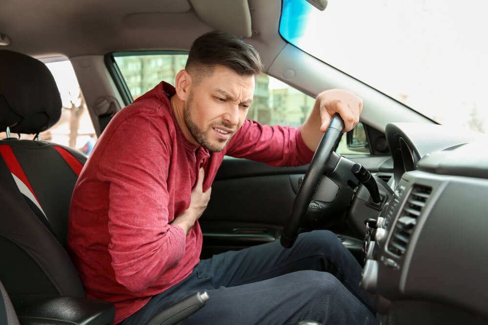 Driver experiencing chest pain while driving.