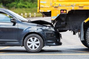 Rear-end collision between car vs yellow truck in the road