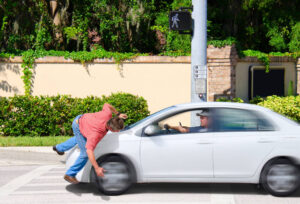 Pedestrian got hit by distracted driver upon crossing.