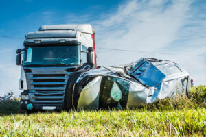 Truck accident involving car in the road