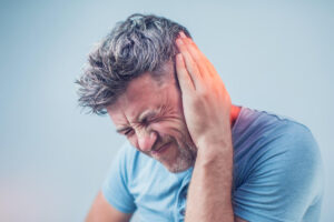 Man suffering hearing loss feeling ear pain.