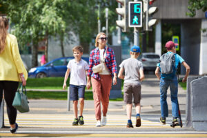Pedestrians crossing on green signal to walk.