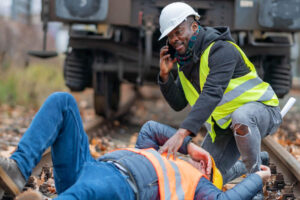 Railroad worker calling for help to rescue coworker.