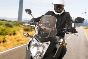 Motor rider strolling in the country road.