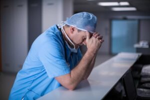 Depressed doctor feeling sad on the failed operation.