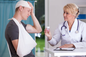 Young man suffering brain injuries talking to his doctor regarding his check up.
