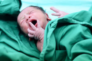 Newborn baby crying in the delivery room.