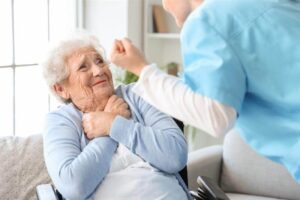 Senior woman scared of angry nurse at home.