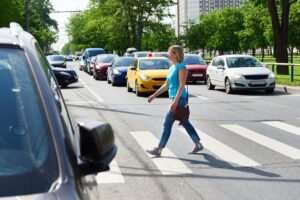 Lady pedestrian crossing street.
