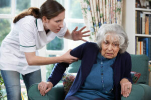 Senior woman being abused by her caretaker.