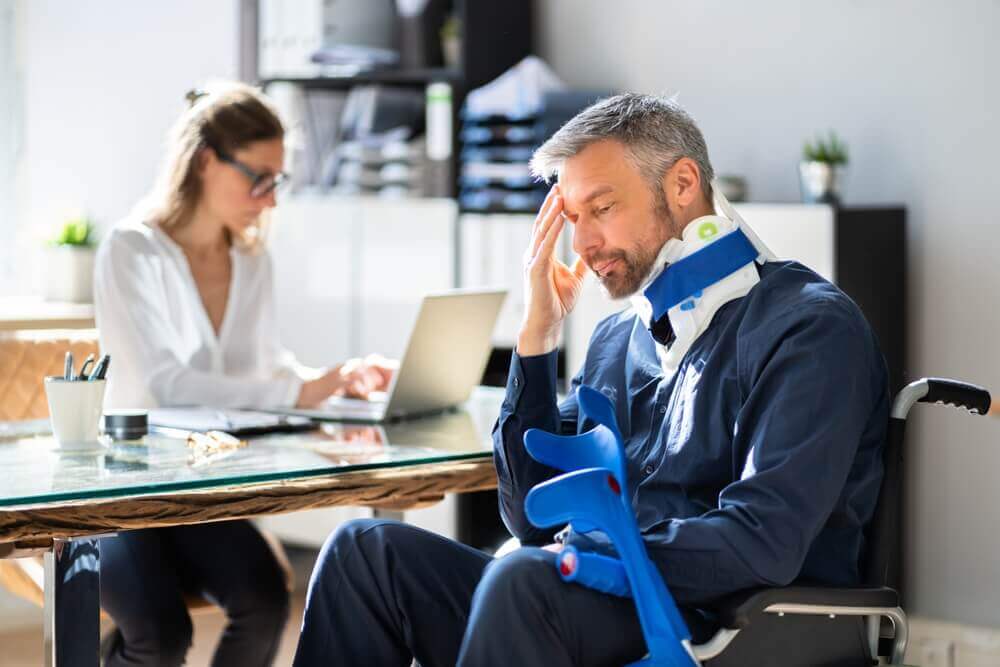 Injured employee on wheelchair applying for personal injury claims.