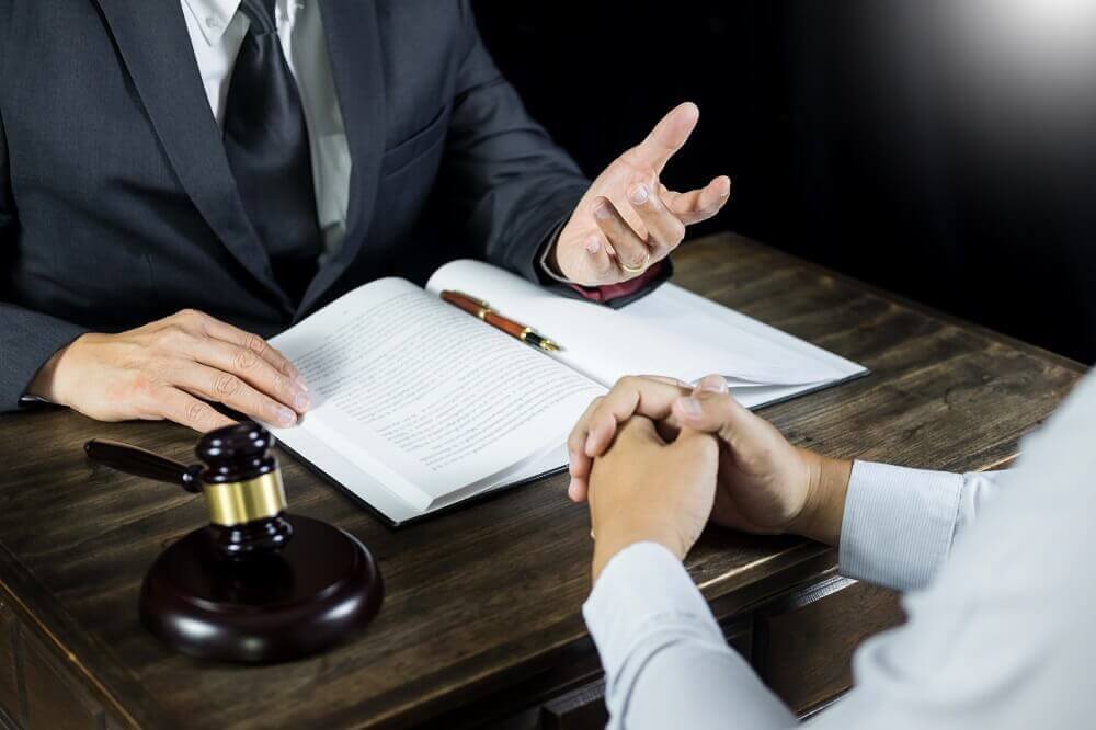Client and lawyer discussing personal injury case.