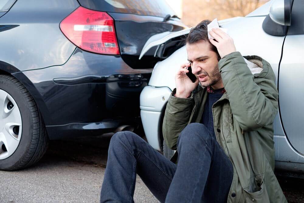 Injured driver calling for help from car accident.