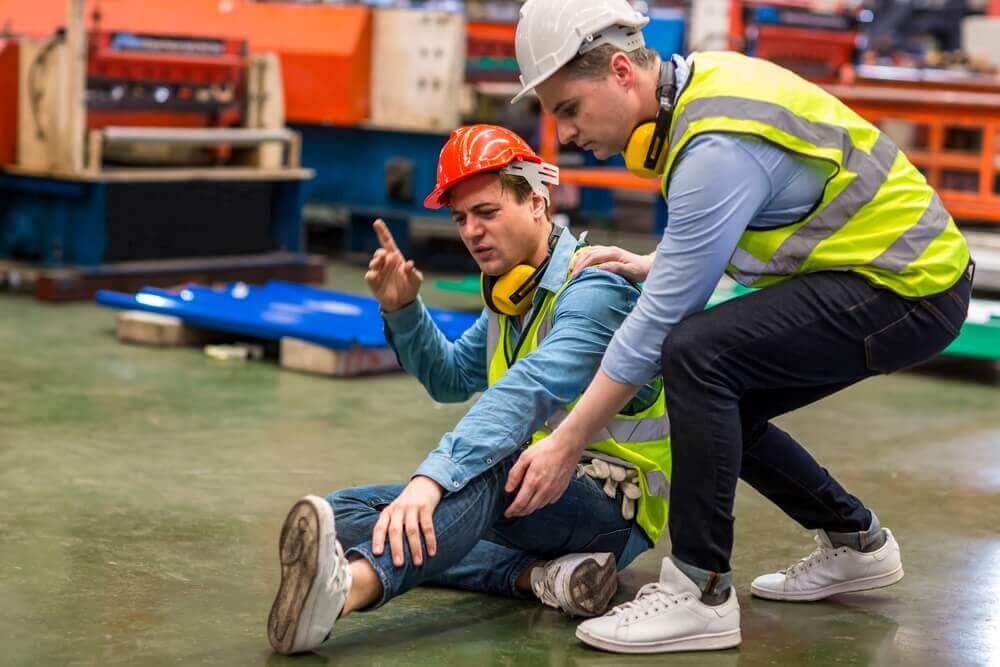 Injured man on the job helped by his teammate.