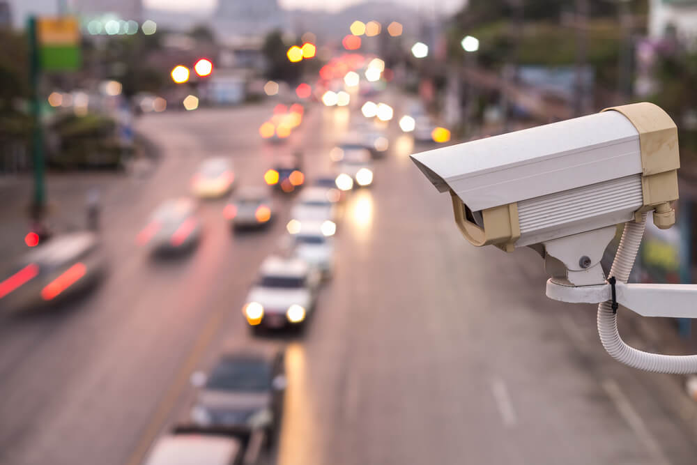 Close up Security CCTV camera operating over the road.