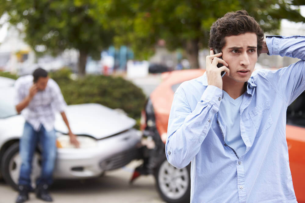 Worried young driver calling her parents to report accident.
