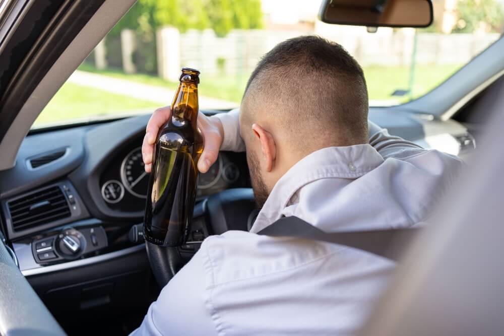 Super drunk driver sleeping while driving.