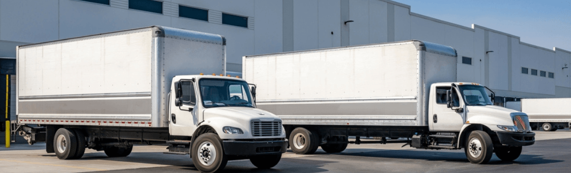 White delivery trucks on parking.
