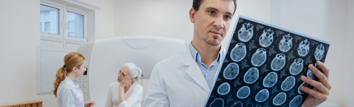 Doctor reading brain scan report from patient.