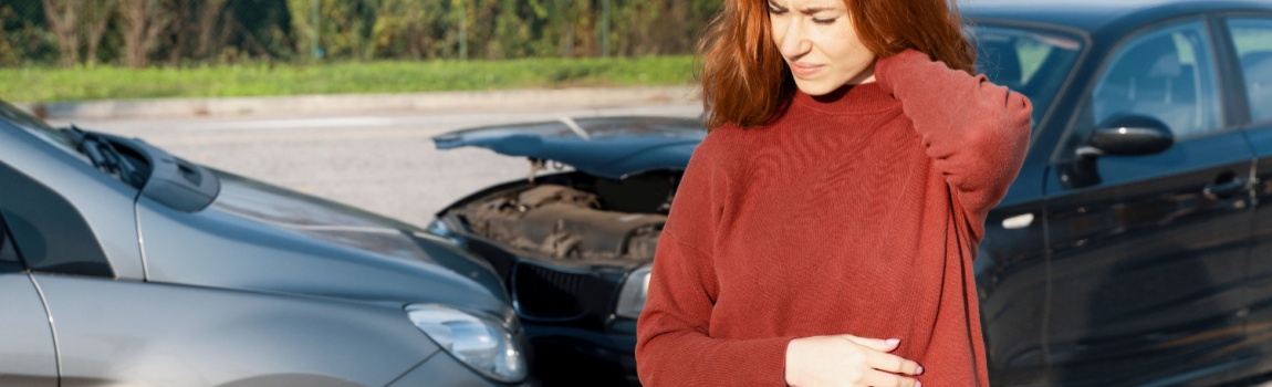 Female driver suffering whiplash injury from accident.