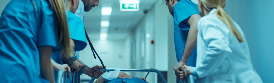 Medical team rushing to emergency room due to patients critical condition.