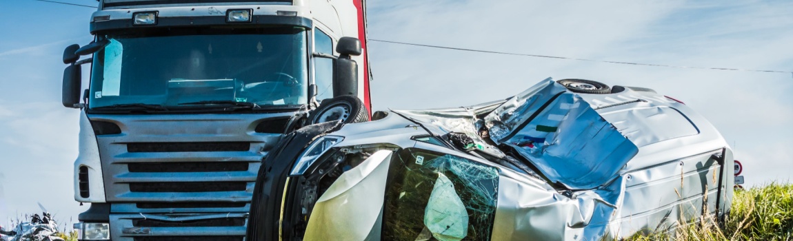 Truck accident involving car in the road