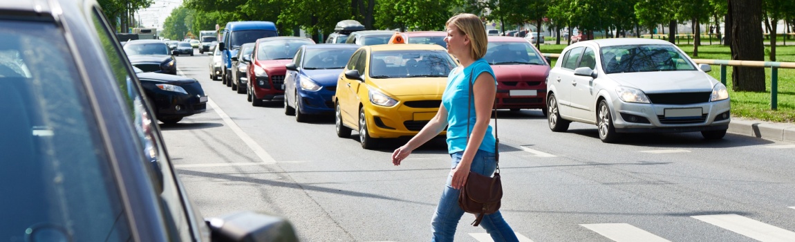 Woman crossing in pedestrian lane