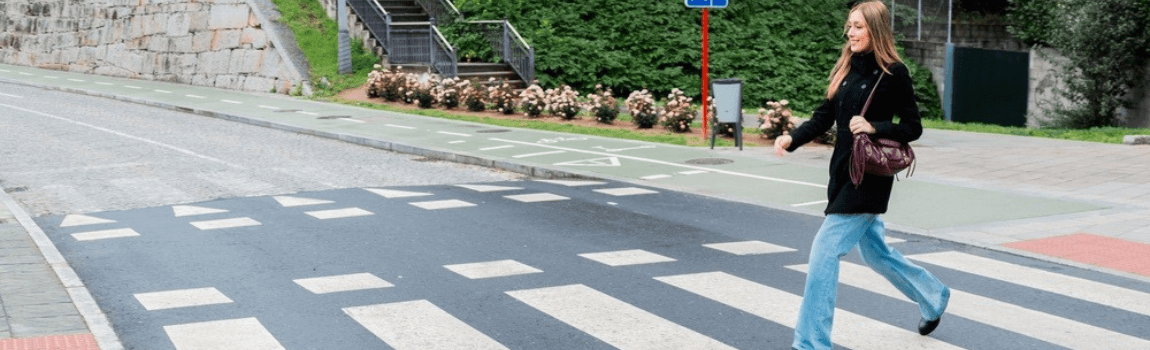 Young woman crossing the pedestrian lane.