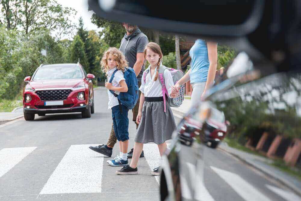 School children crossing the pedestrian lane for safety.