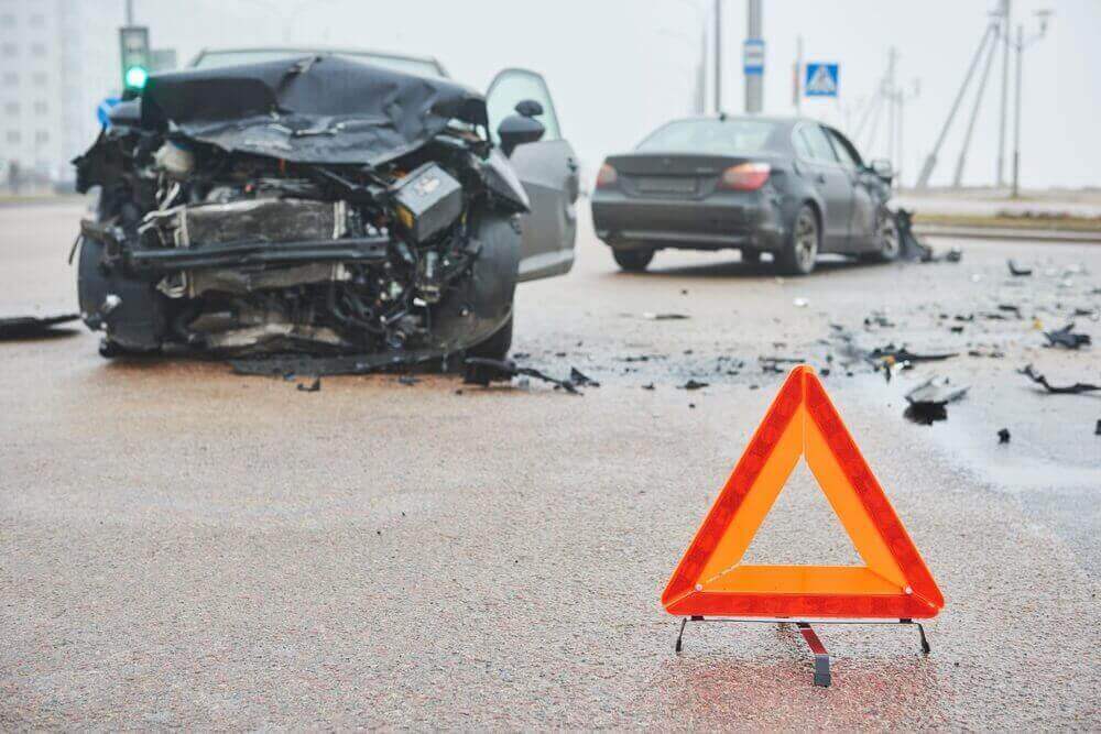 Highway intersection car collision accident with warning sign